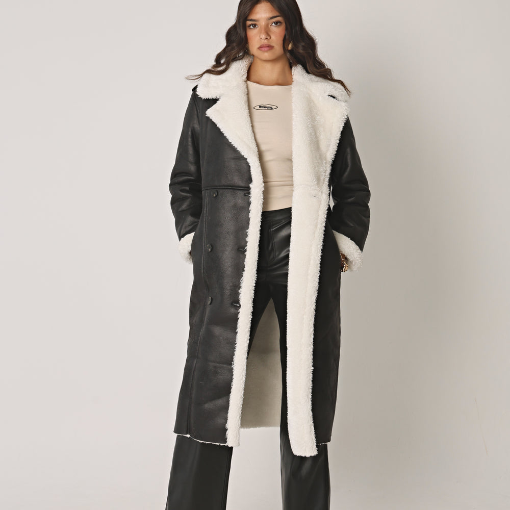 
                      
                        BLACK AND CREAM LONGLINE SHEARLING COAT
                      
                    